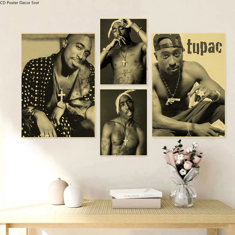 A display of three black and white posters featuring Tupac, arranged on a light wood shelf.