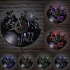 A vintage vinyl record wall clock featuring a black disc design and the word JAZZ on a brick background.