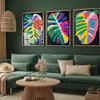 Three canvas prints featuring retro wildflower landscapes displayed on a dark green wall above a sofa.