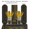 A set of black and gold disposable dinnerware including plates, cups, straws, and napkins displayed on a table.