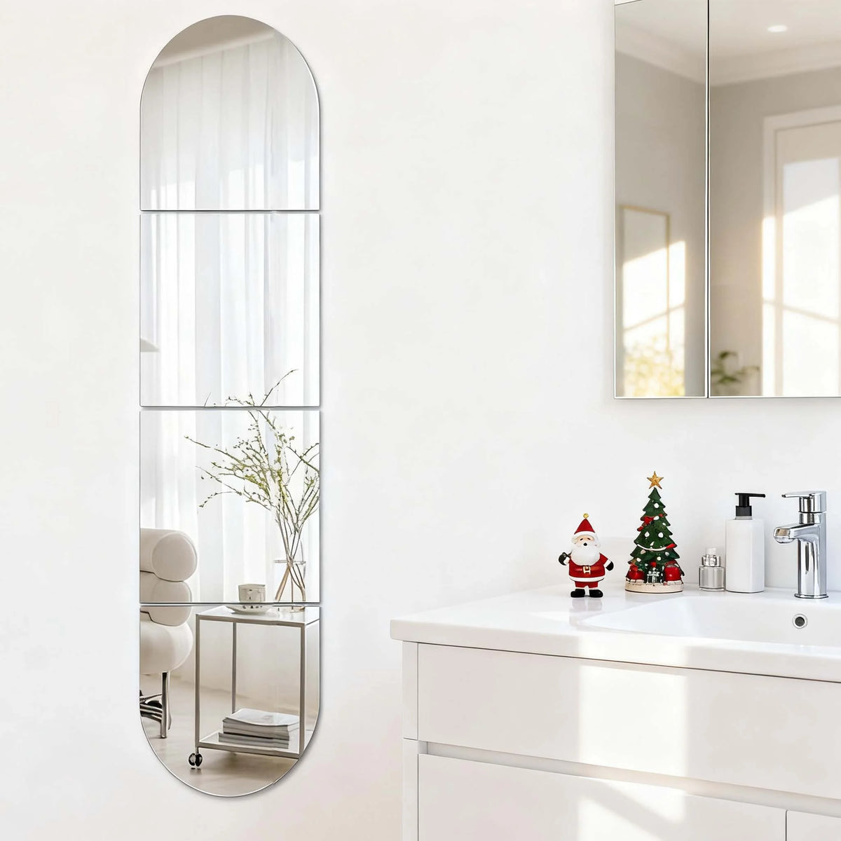 A vertical acrylic mirror wall decal with a rounded top, featuring a rectangular mirror and a small shelf.