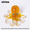 A translucent yellow crystal octopus statue with spiraled arms and tentacles.