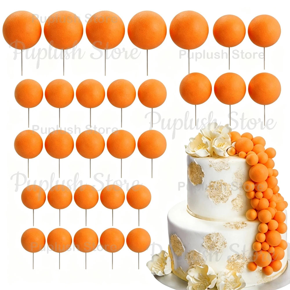 A set of round orange foam cake toppers displayed on white sticks.