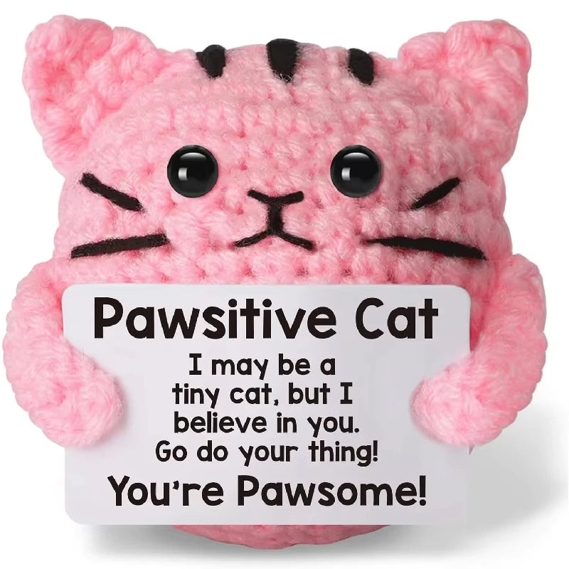 A pink fluffy cat plush toy with black stripes and large eyes.