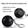 A black magic ball with a keychain attached, used for prophecy or stress relief.