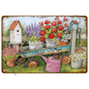 A vintage metal tin sign depicting a garden scene with potted flowers, a wooden birdhouse, and gardening tools.
