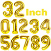 A set of gold foil number balloons spelling out thirty-two inches.