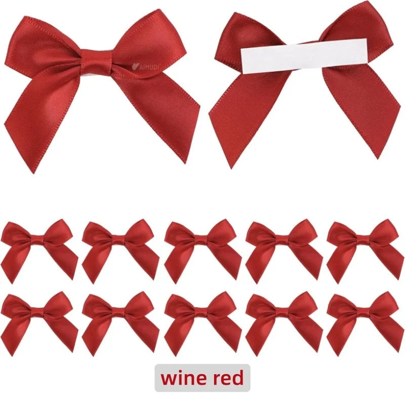 A collection of red satin ribbon bows with white tape, used for gift wrapping and craft projects.