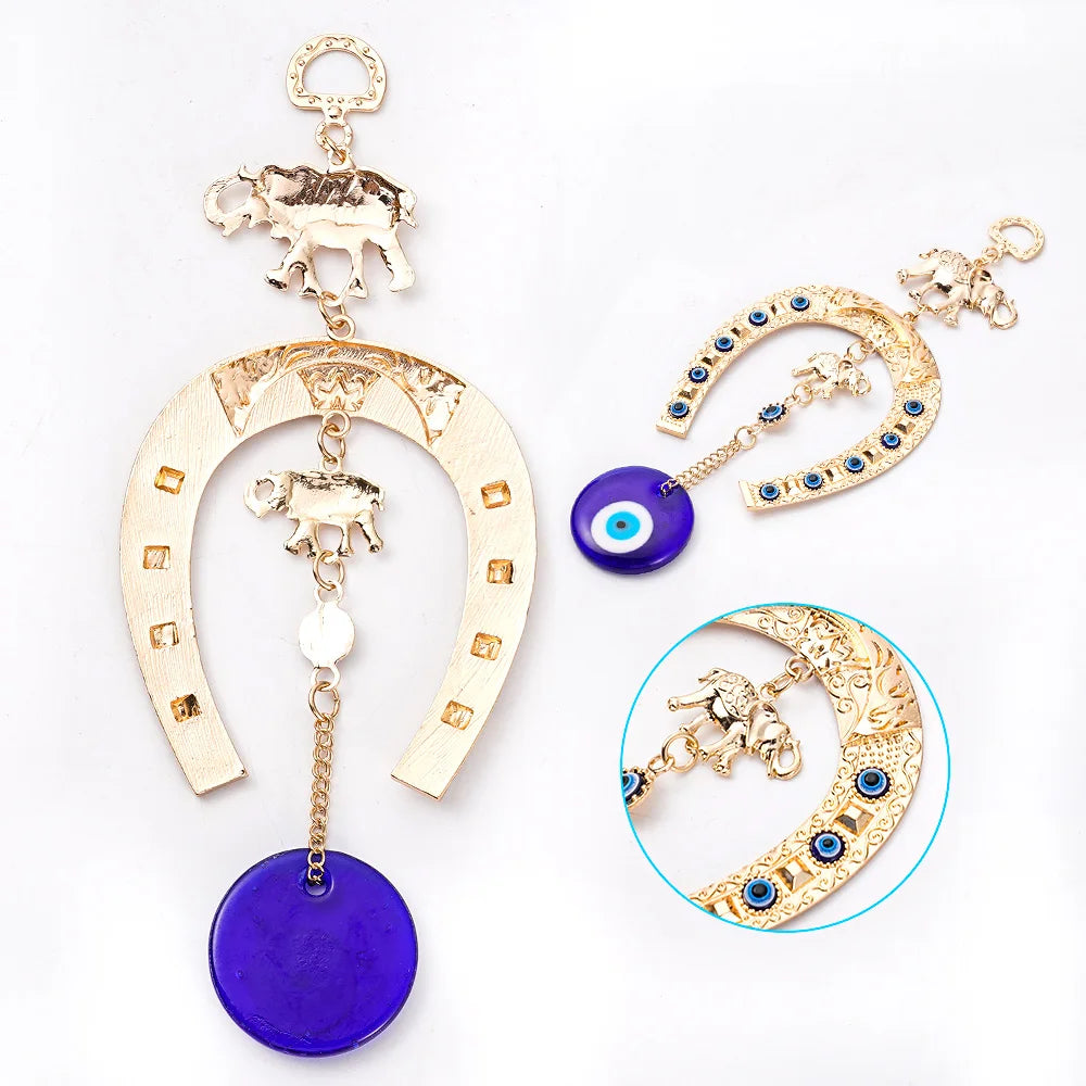 A gold and purple Turkish blue eye amulet horseshoe wall hanging featuring an elephant charm.