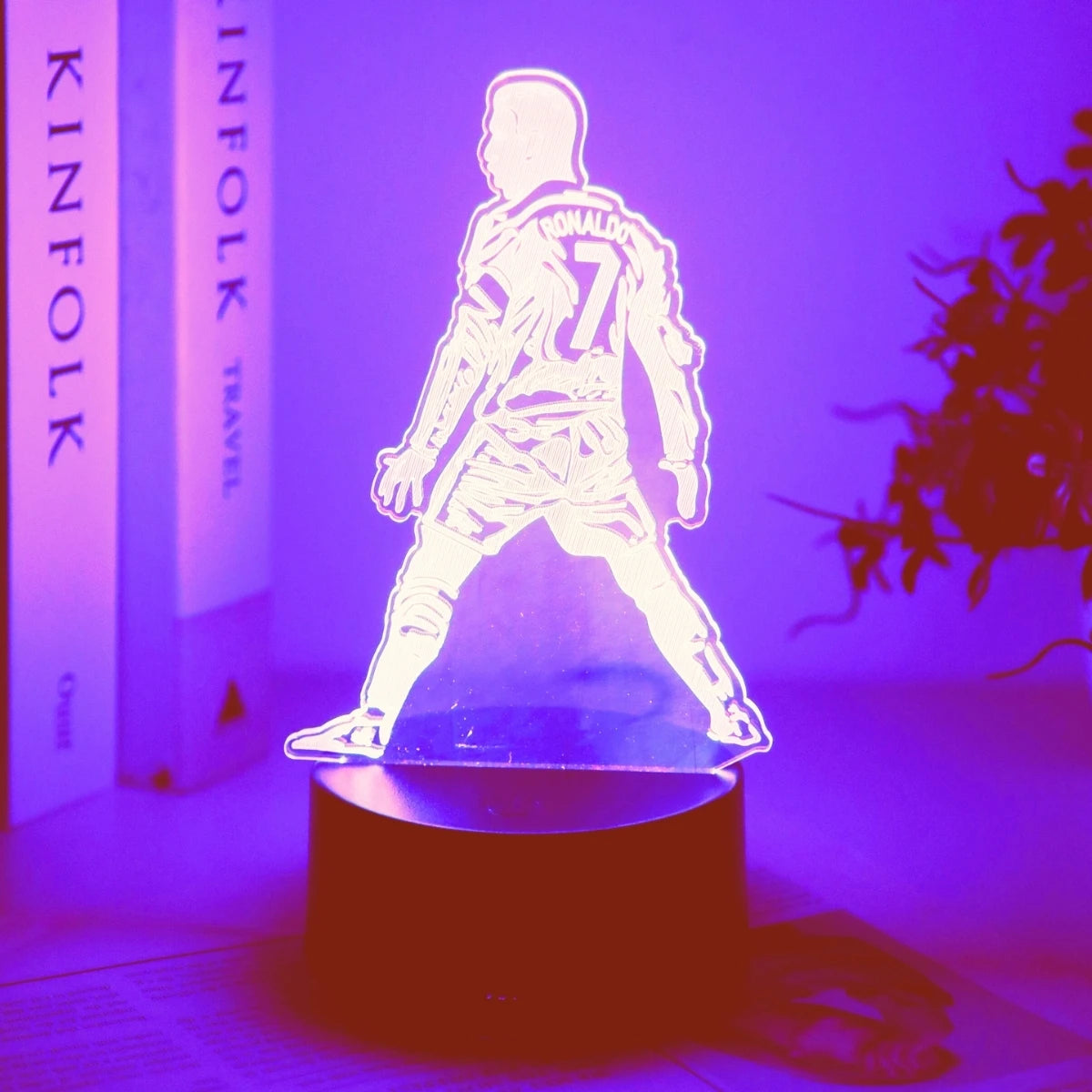 A glowing 3D football player figure with the number 7 stands on a dark base against a purple light background.