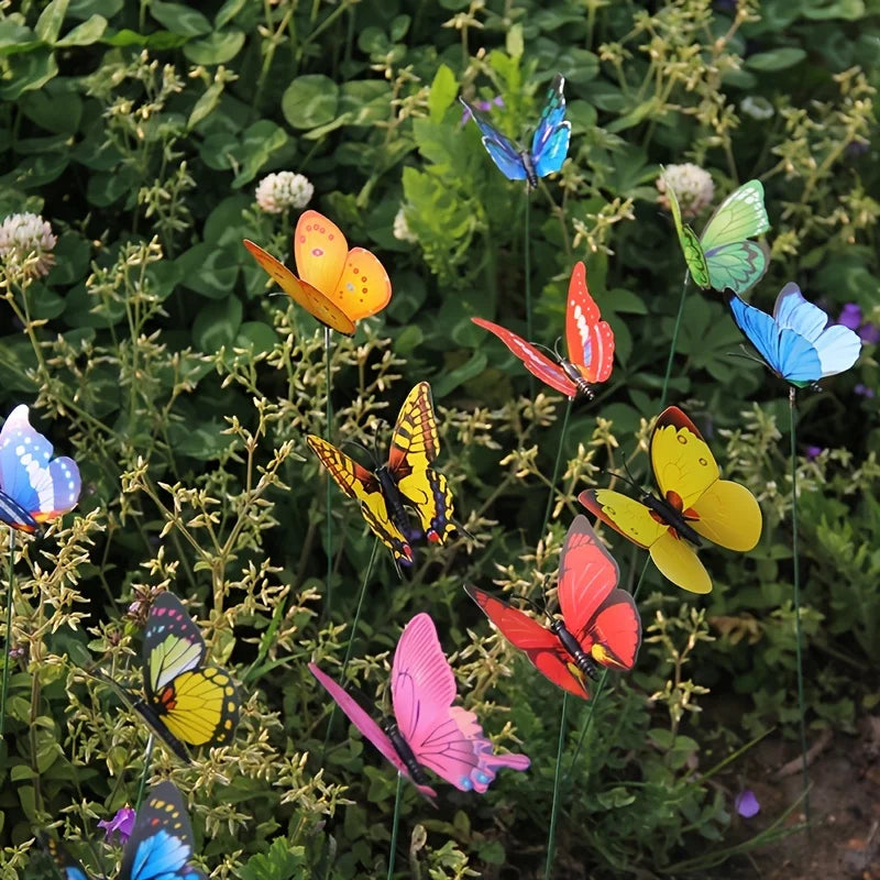 A collection of colorful butterfly garden stakes with various butterfly shapes and colors growing in green foliage.