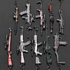A collection of realistic miniature gun models on metal keychains.
