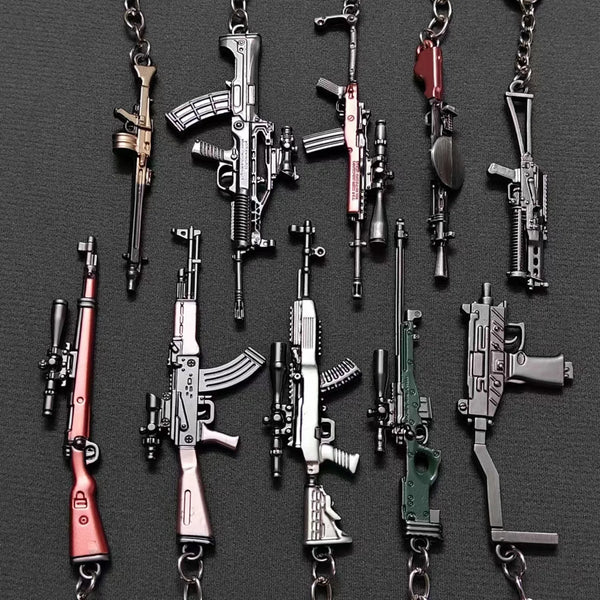 A collection of realistic miniature gun models on metal keychains.