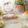 A set of pink floral thank you hand fans for celebrating with us displayed on a table.