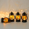 Three orange glowing Halloween LED pumpkin and ghost hanging lanterns displayed on a white surface.