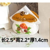Handcrafted miniature mushroom tableware set with a golden glaze and white icing on a white ceramic base