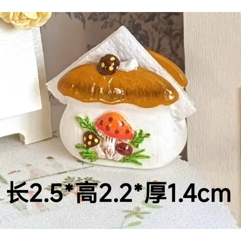 Handcrafted miniature mushroom tableware set with a golden glaze and white icing on a white ceramic base