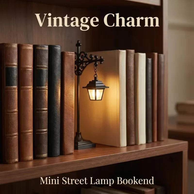 A wooden bookshelf displaying vintage-style books and a small black street lamp bookend with a warm glow.