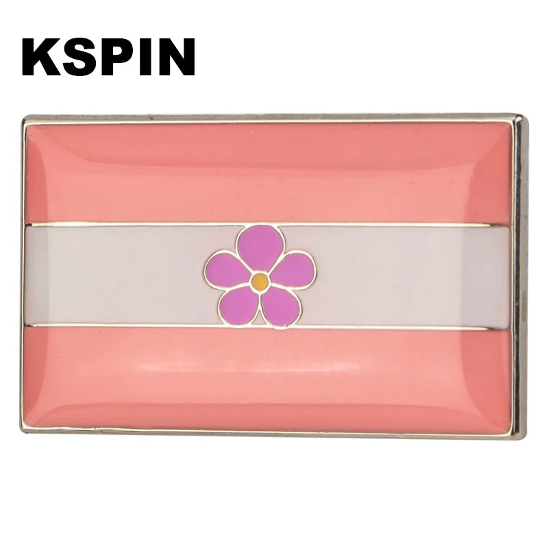 A lapel pin featuring horizontal stripes of pink and white with a purple flower design.