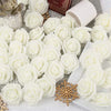 White artificial foam rose decorations arranged on a white surface.