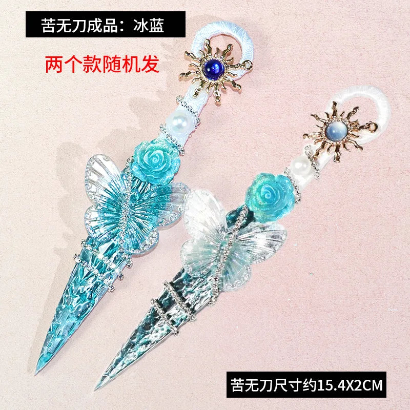 A pair of blue and clear decorative kunai utility knives with floral accents and pearl beads.