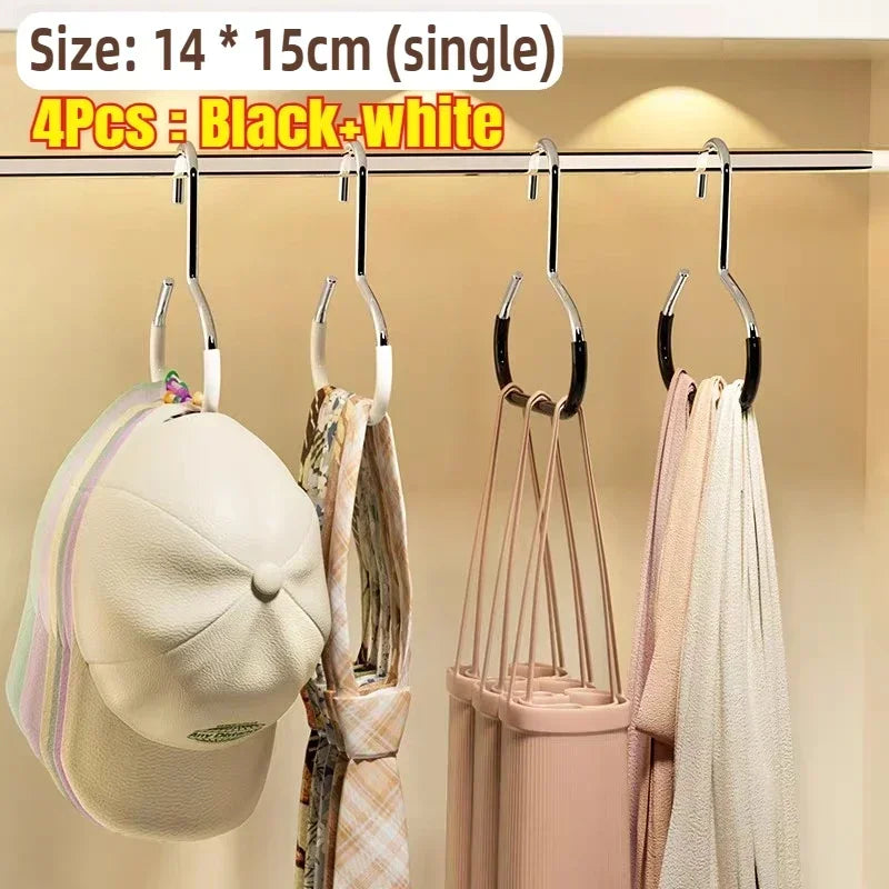 Four black and white round multi-purpose closet hooks hanging on a rod