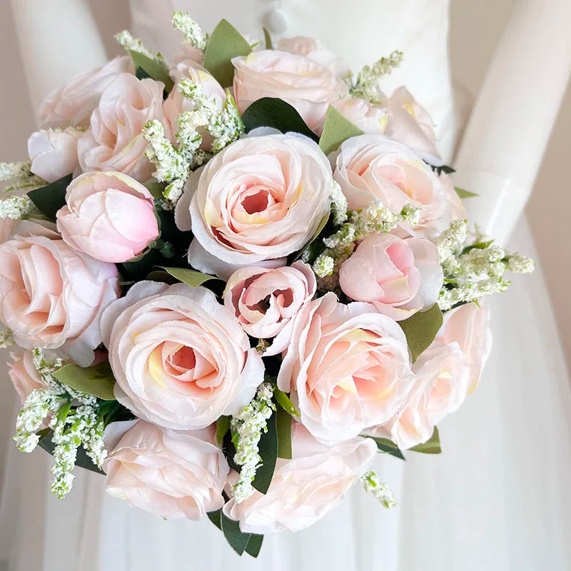 A lush bridal bouquet of pink and blush roses with a champagne finish, arranged in a natural style.
