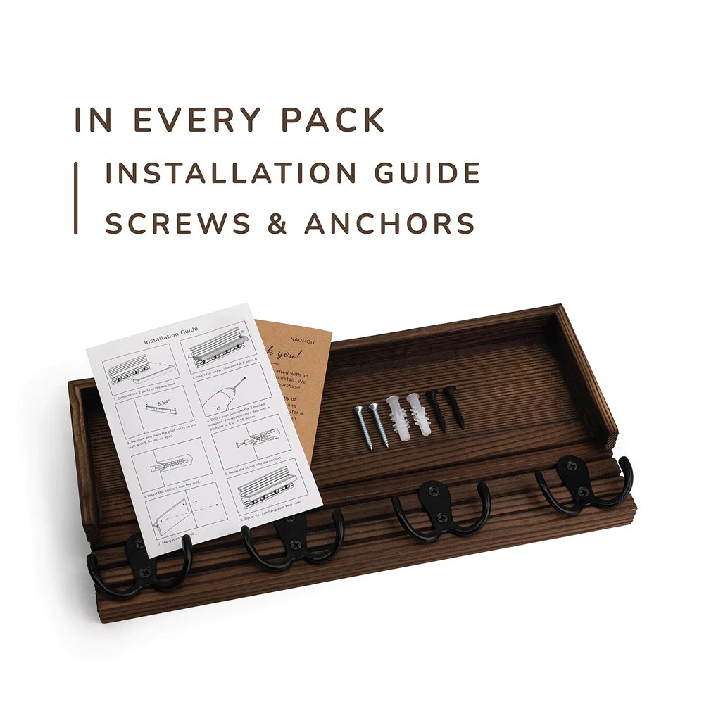 A wooden key holder organizer displaying an installation guide, screws, and anchors.