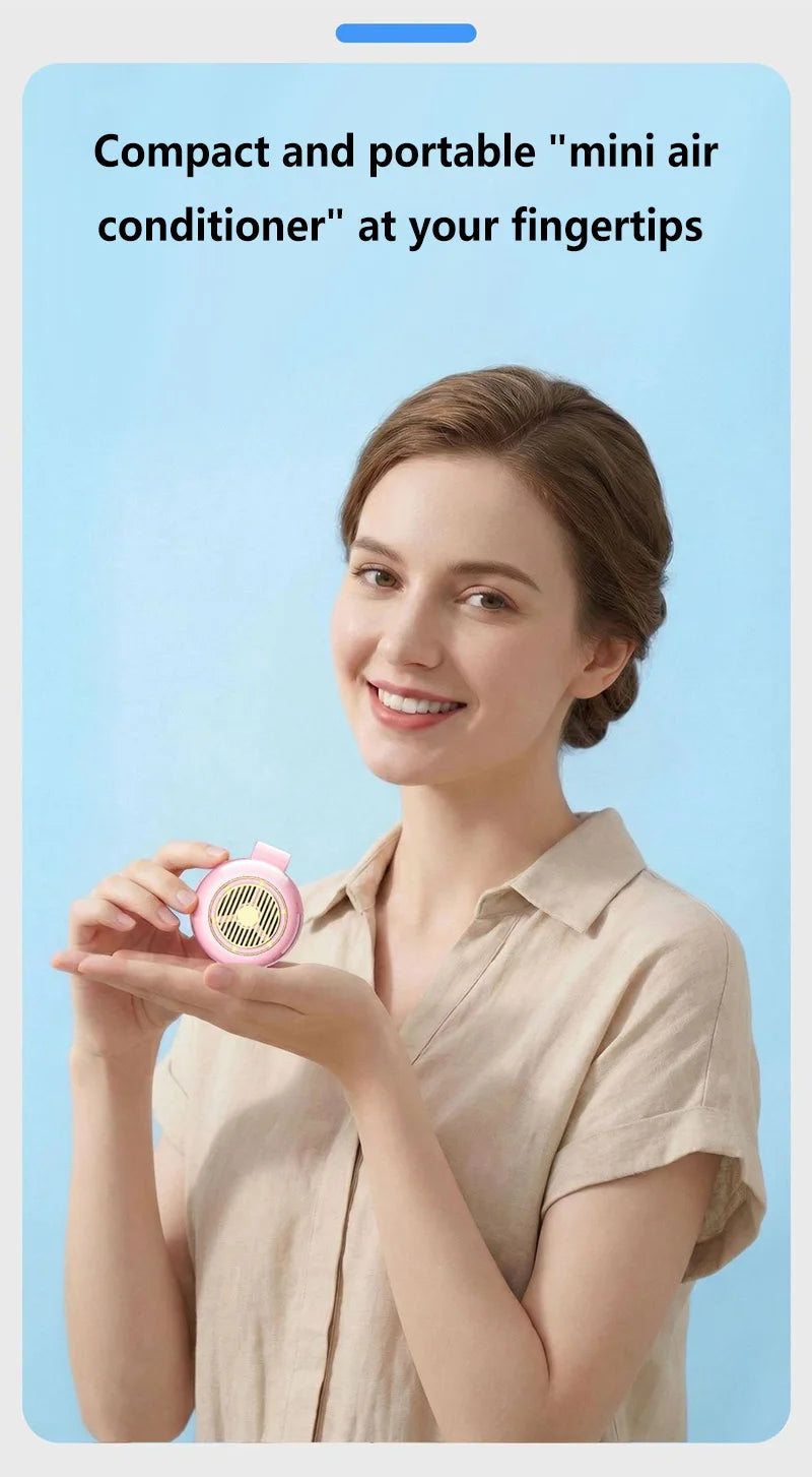 A woman holds a pink portable mini air conditioner fan near her fingertips.