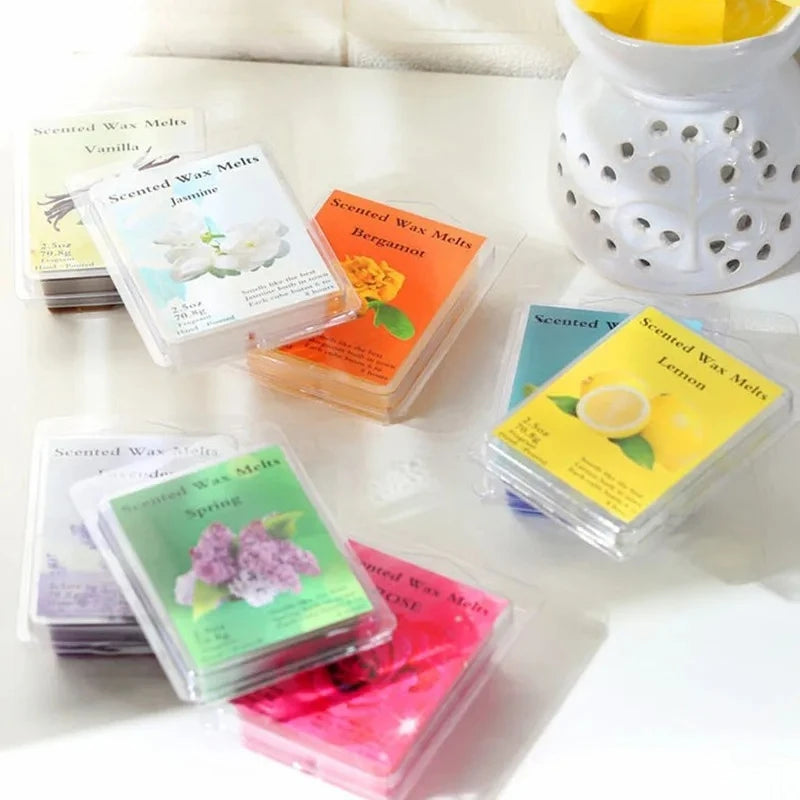 A collection of scented wax melts in various colors and scents, including vanilla, jasmine, bergamot, and lemon.