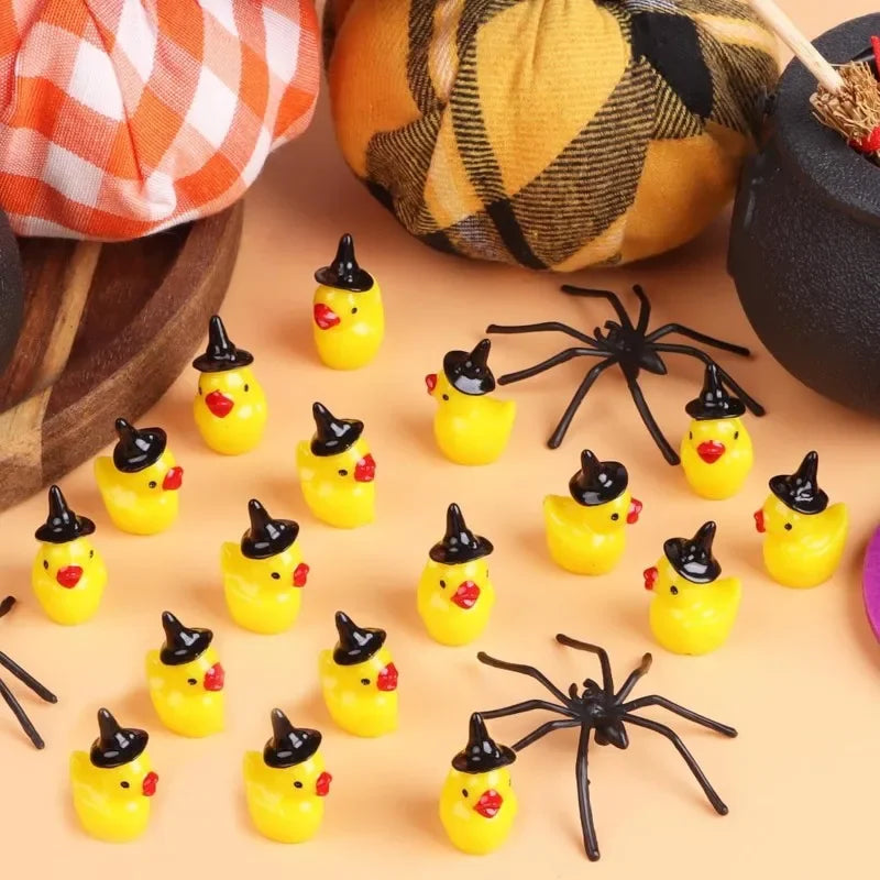 A collection of miniature resin witch hat ducks in yellow and black, displayed on a light background.