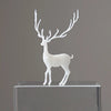 A white resin ornament of an elk deer with antlers standing on a clear glass base.