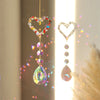 A hanging crystal sun and moon piece featuring iridescent glass beads and a teardrop pendant.