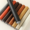 A stack of self-adhesive PU leather furniture repair patches in various shades of brown, orange, and beige.