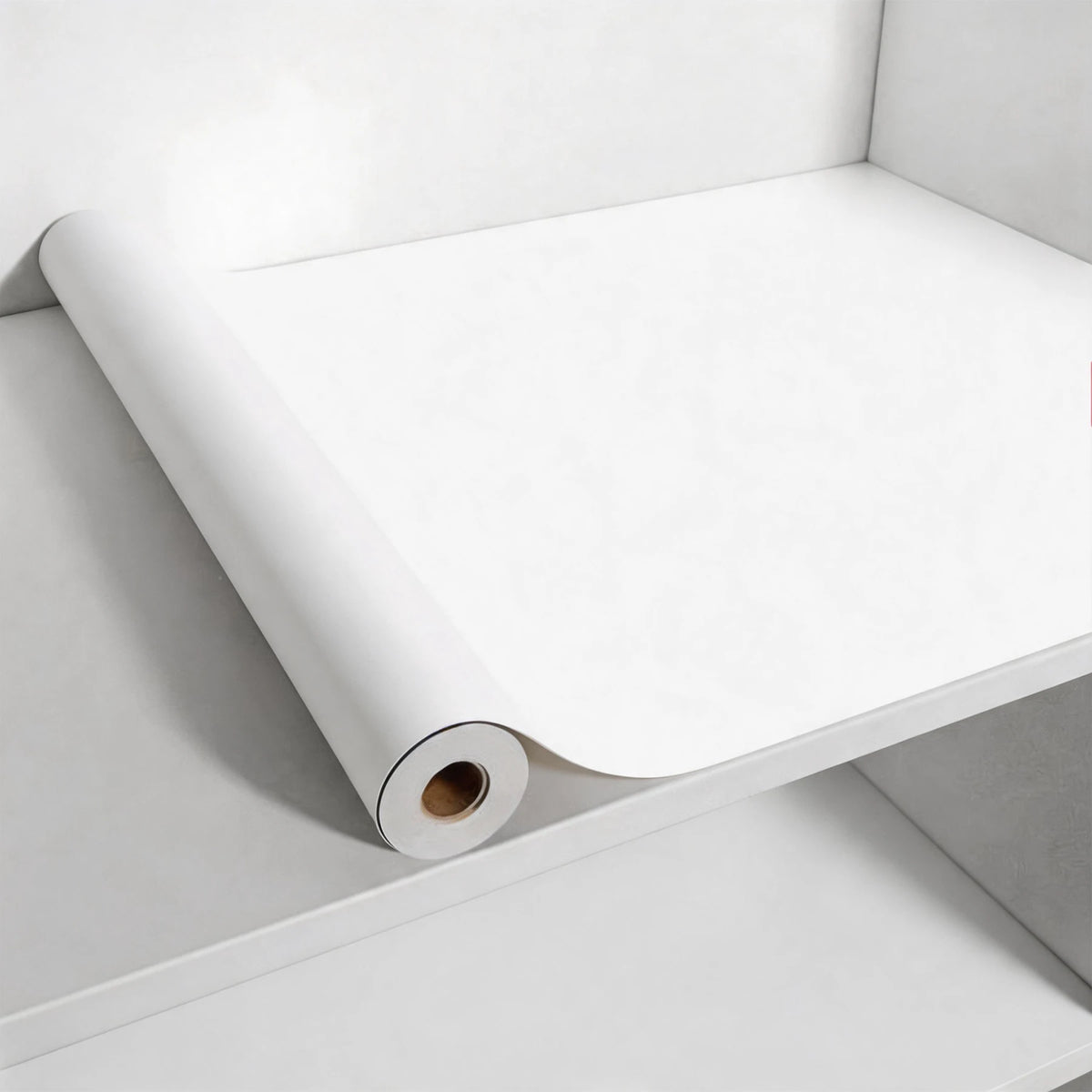 Roll of white matte peel and stick decor stickers placed inside a white container.