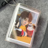 A clear plastic photo album containing a picture of a person with dark hair and light eyes.