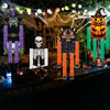 A set of Halloween hanging ornaments featuring a witch ghost, an orange pumpkin, and a skeleton figure.