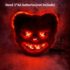 A glowing orange animal face mask with fierce eyes is shown against a dark, textured background.