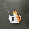 A white acrylic decor featuring an orange and white cat head with long whiskers, mounted on a small base.