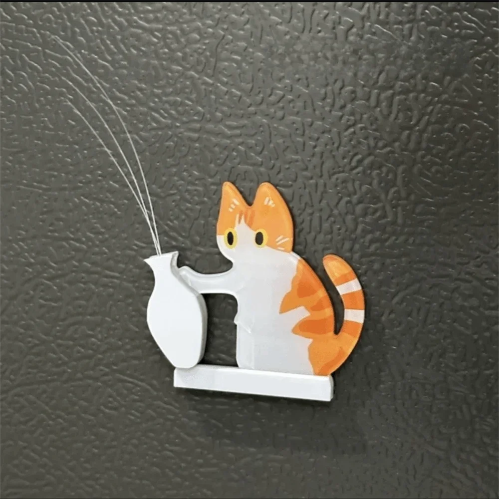 A white acrylic decor featuring an orange and white cat head with long whiskers, mounted on a small base.
