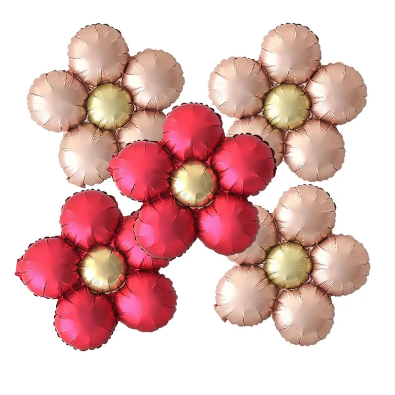 A set of five matte foil flower balloons in shades of red and pink with a daisy design.