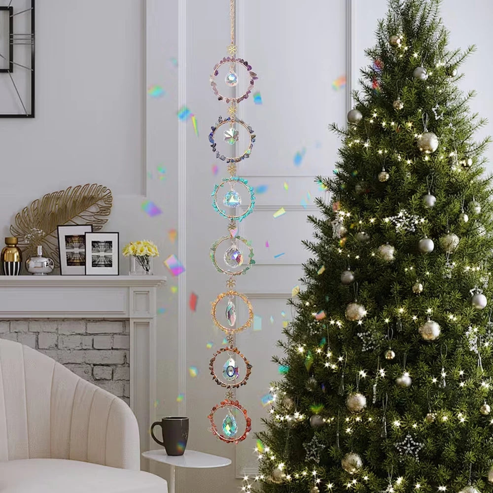 A decorated Christmas tree with sparkling lights and hanging crystal ornaments in a bright room.