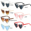 A collection of pearl-embellished heart-shaped sunglasses in various colors including white, black, beige, pink, leopard prin