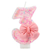 Glitter number cake candle with a bow shaped like the number 1 in pink and glitter