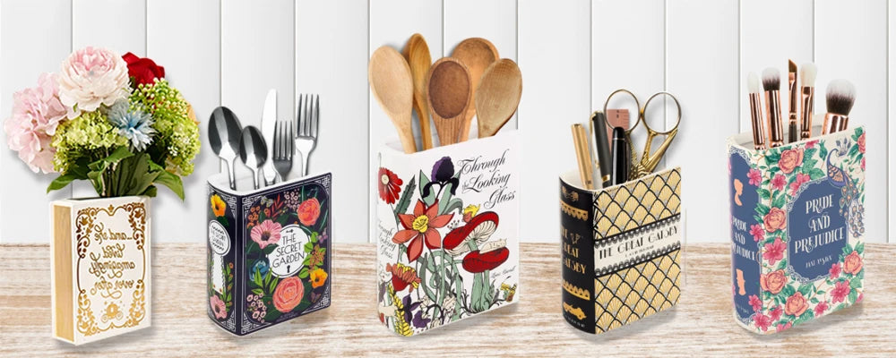 A ceramic book-shaped vase with a vintage finish displayed alongside various kitchen utensils and floral arrangements.