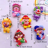 A collection of colorful resin clown charms in various sizes and styles for DIY crafts