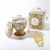 A gift set of soy wax aromatherapy candles in a decorative tin box and glass holder.