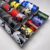A collection of rolled camouflage vinyl wrap film in various colors including green, blue, red, and black.