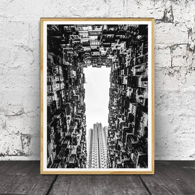 Black and white photograph of a city skyline viewed through an architectural corridor