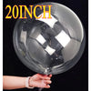 A large clear bubble balloon is being held by a hand against a dark background.